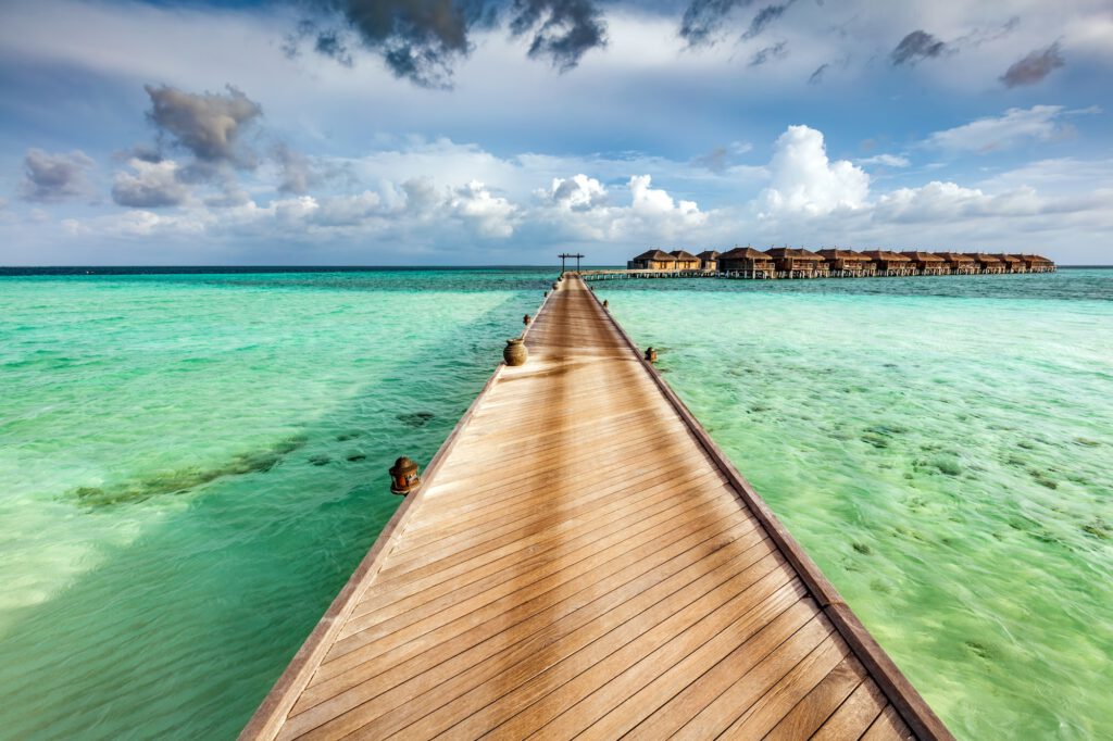 Wooden jetty on the ocean on Maldives Islands.